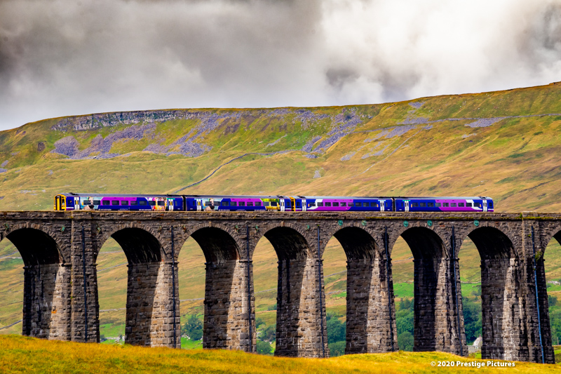 Northern train running across the Ribblehead viaduct